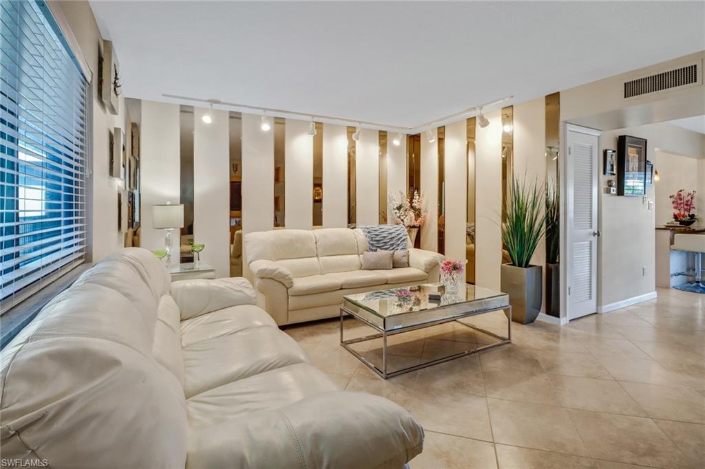 788 Park Shore Drive, Unit E32 Naples, FL 34103 - Photo 6 of 35 a living room with furniture and large windows