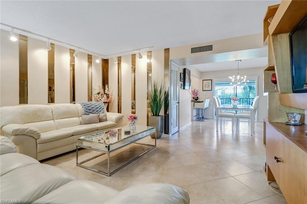 788 Park Shore Drive, Unit E32 Naples, FL 34103 - Photo 7 of 35 a living room with furniture and a large window