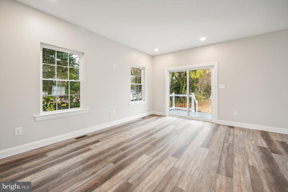 459 Berkley Road Mantua, NJ 08051 - Photo 11 of 28 an empty room with wooden floor and windows