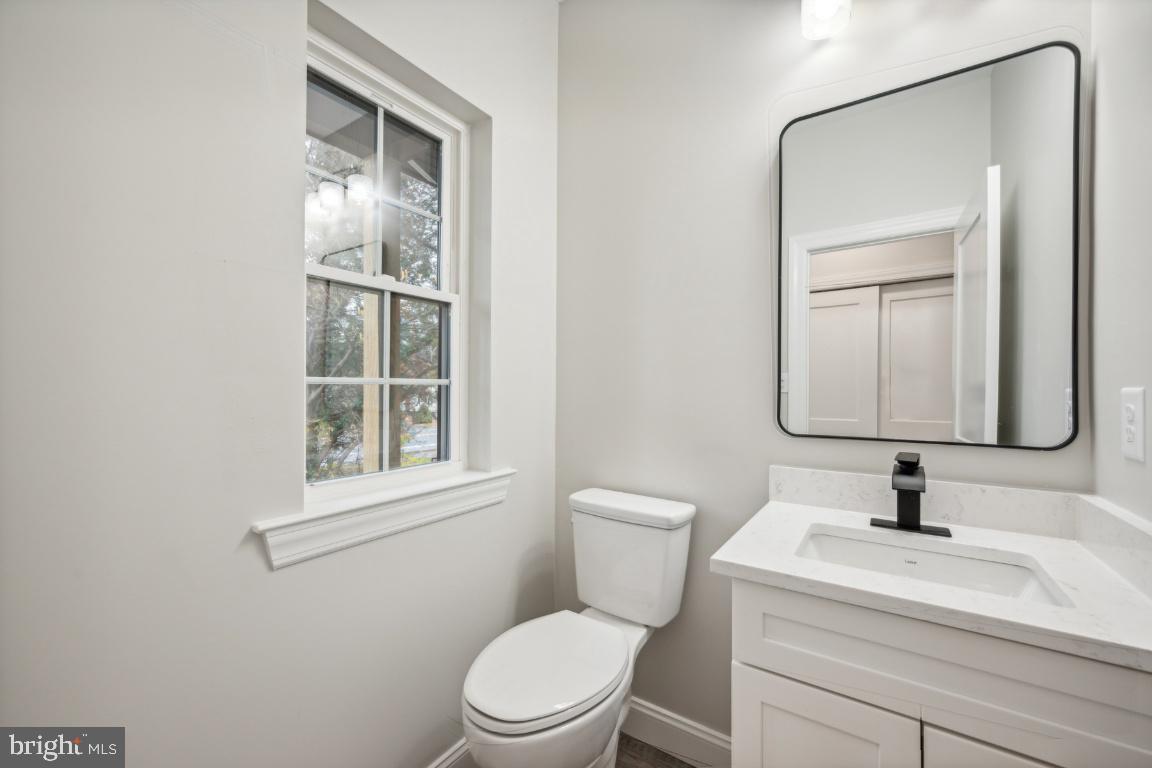 459 Berkley Road Mantua, NJ 08051 - Photo 14 of 28 a bathroom with a toilet a sink and mirror