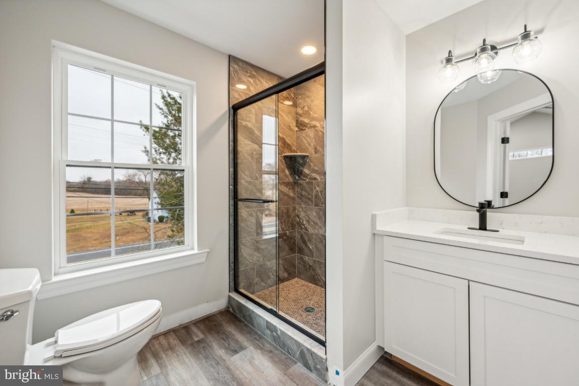 459 Berkley Road Mantua, NJ 08051 - Photo 19 of 28 a bathroom with a toilet a sink and a mirror