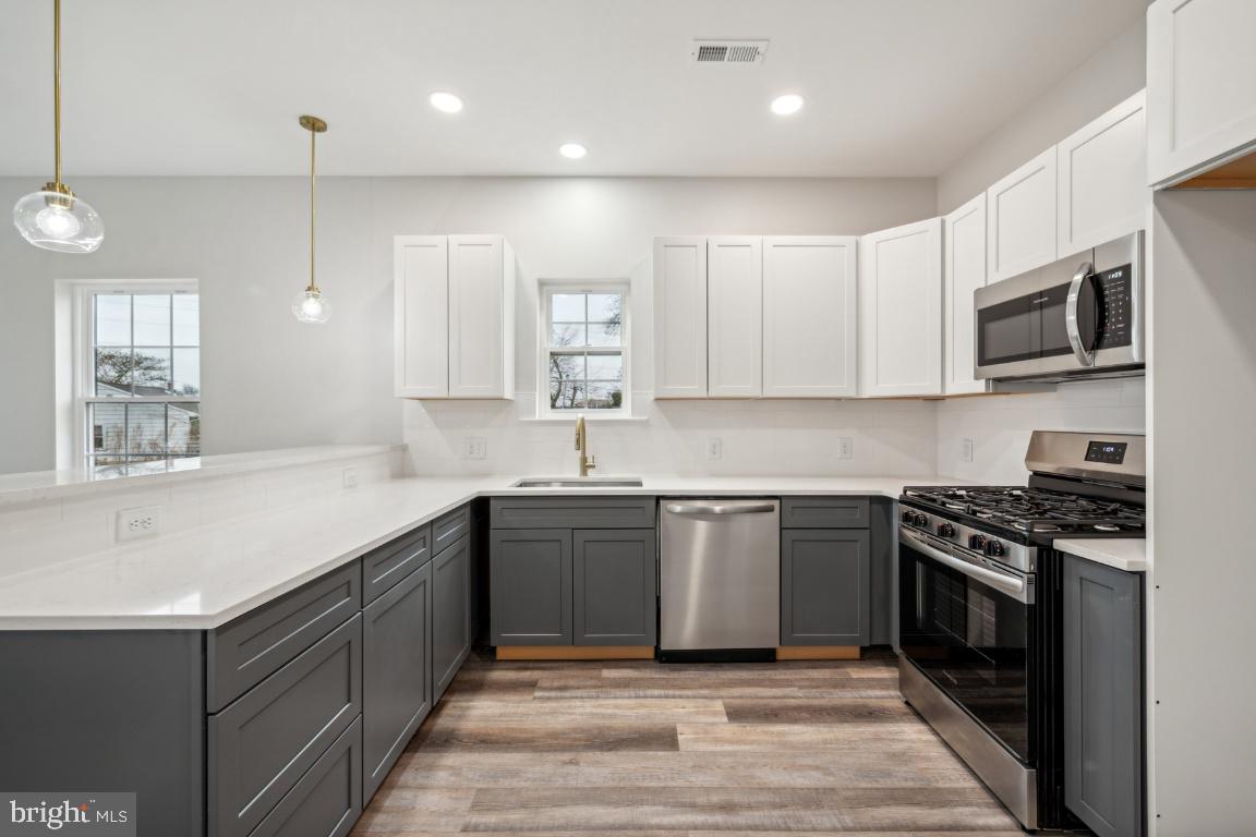 459 Berkley Road Mantua, NJ 08051 - Photo 2 of 28 a kitchen with stainless steel appliances granite countertop a sink a stove top oven and granite counter tops