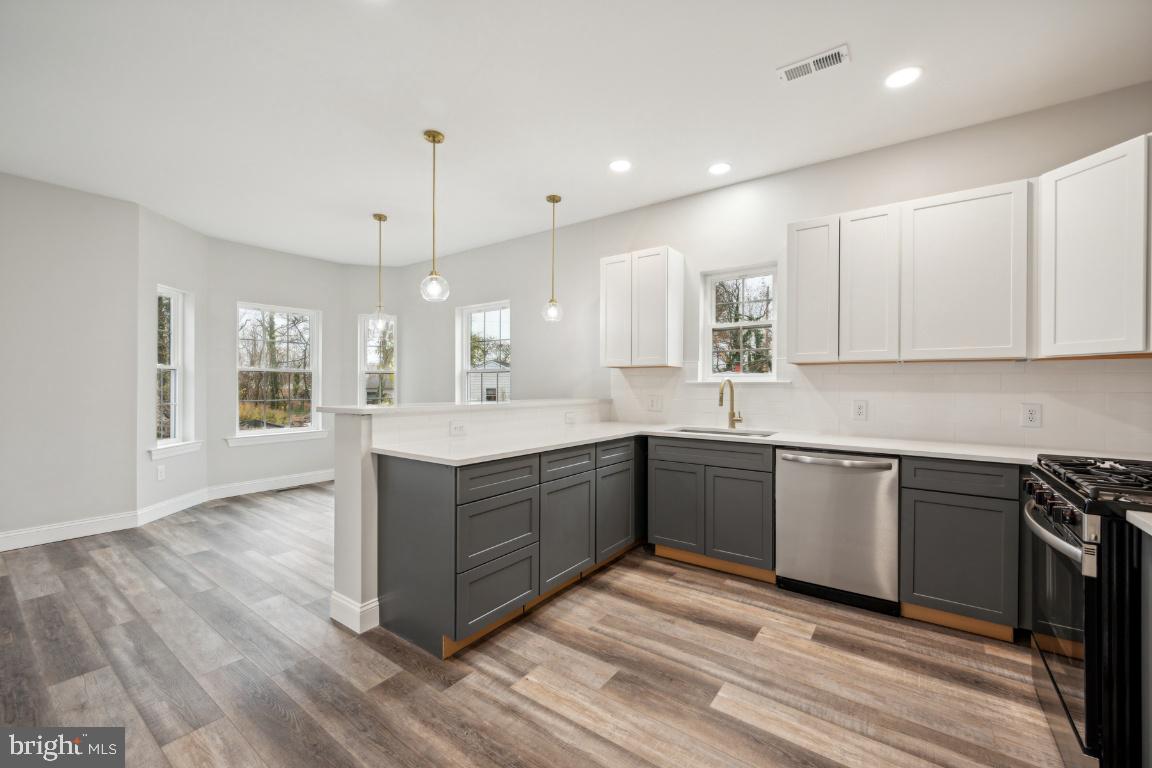 459 Berkley Road Mantua, NJ 08051 - Photo 4 of 28 a large kitchen with granite countertop a large counter top space a sink stainless steel appliances and cabinets