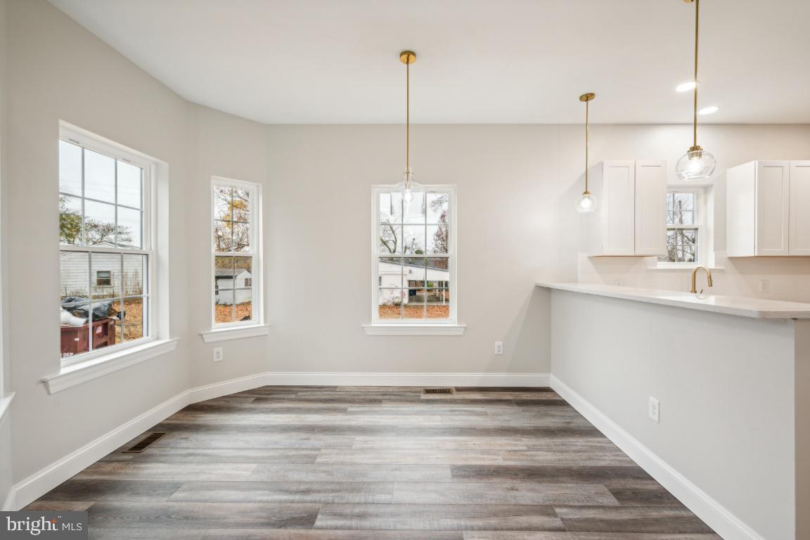 459 Berkley Road Mantua, NJ 08051 - Photo 8 of 28 a view of an empty room with window and wooden floor