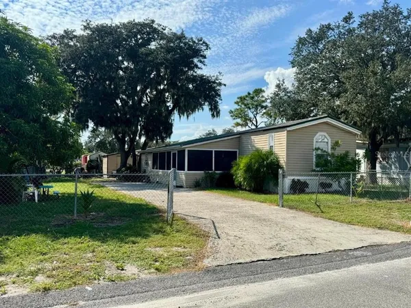 a house that has a tree in front of it