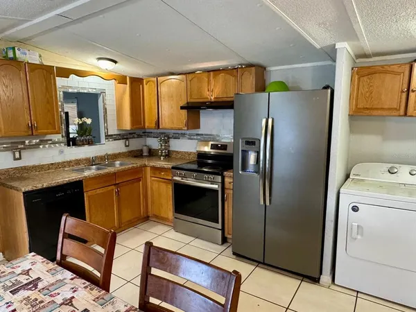 a kitchen with a refrigerator sink and stove