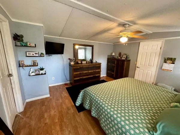 a bedroom with a bed and flat screen tv
