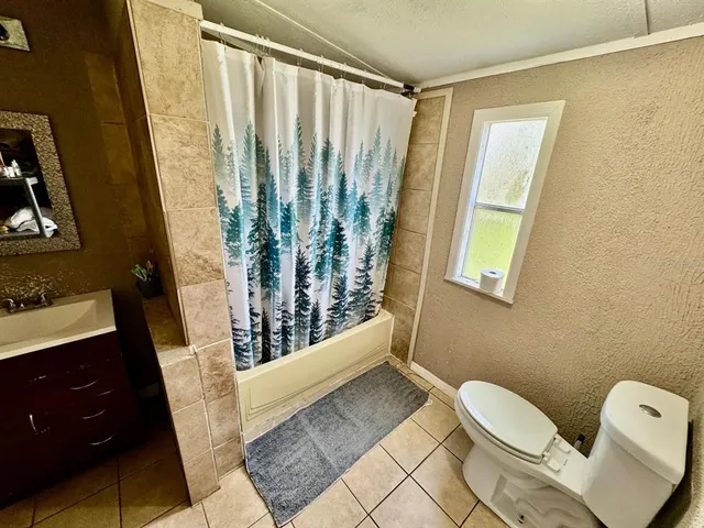 a bathroom with a toilet sink and tub