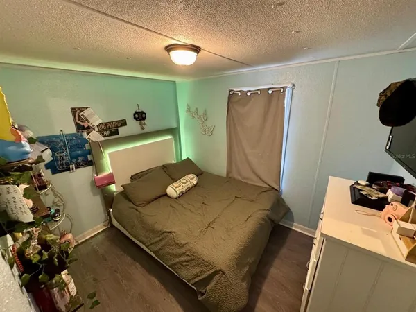 a bedroom with a bed and a large mirror