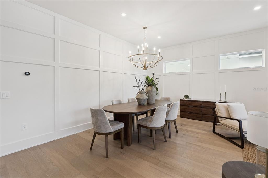 35 West Hazel Street Orlando, FL 32804 - Photo 13 of 60 a view of a dining room with furniture wooden floor and chandelier