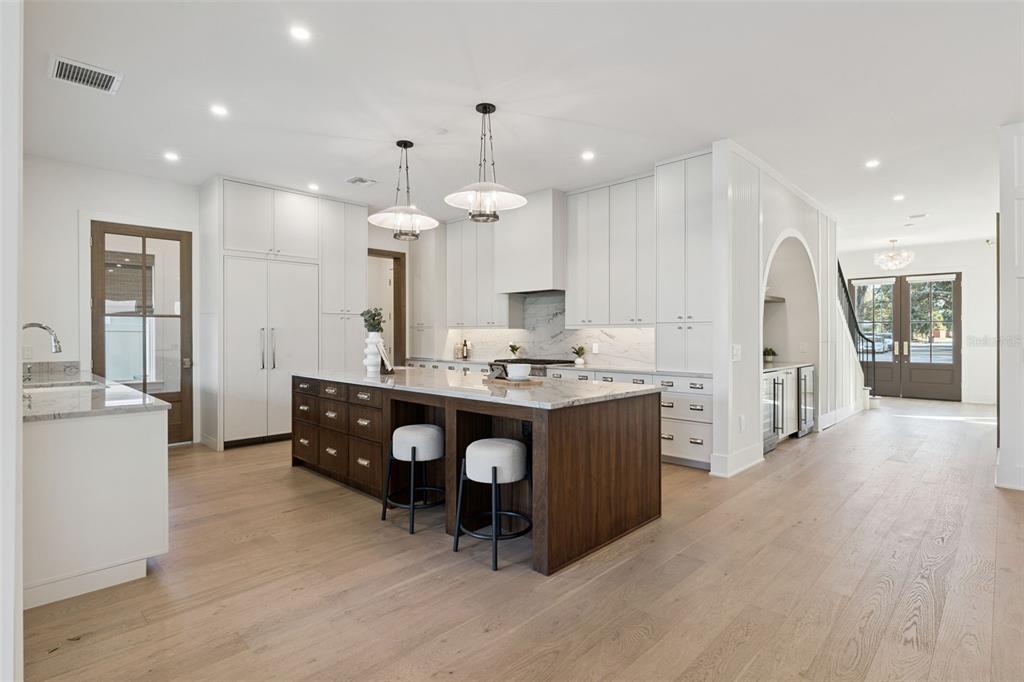 35 West Hazel Street Orlando, FL 32804 - Photo 16 of 60 an open kitchen with a sink dishwasher a dining table and chairs with wooden floor