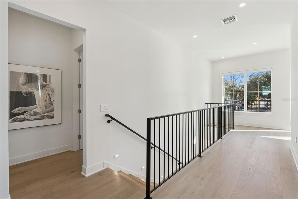 35 West Hazel Street Orlando, FL 32804 - Photo 23 of 60 a view of a hallway with wooden floor and windows