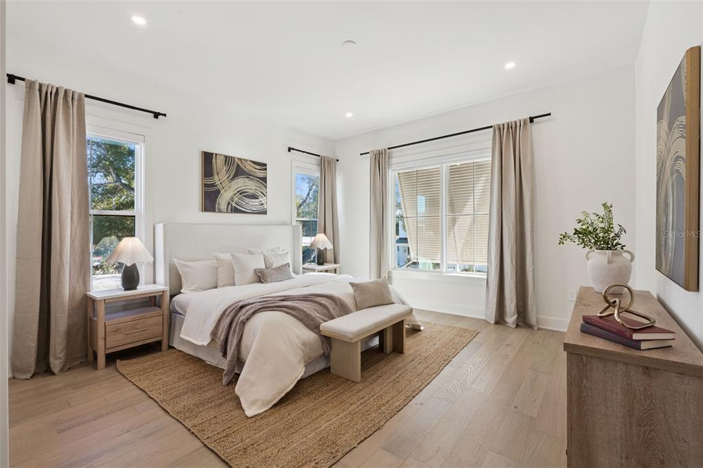 35 West Hazel Street Orlando, FL 32804 - Photo 30 of 60 a spacious bedroom with a bed and a couch