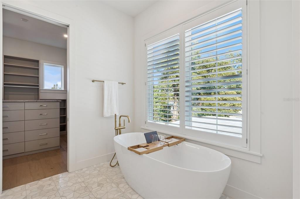 35 West Hazel Street Orlando, FL 32804 - Photo 33 of 60 a white bath tub sitting in a bathroom next to a window
