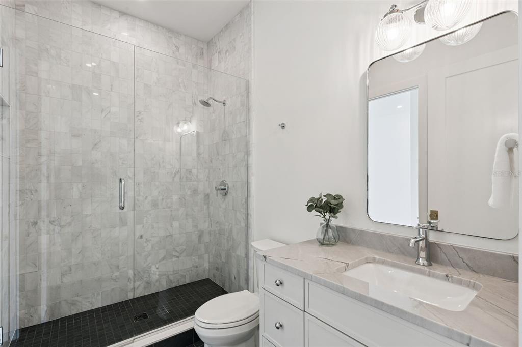 35 West Hazel Street Orlando, FL 32804 - Photo 38 of 60 a bathroom with a granite countertop sink a toilet and shower