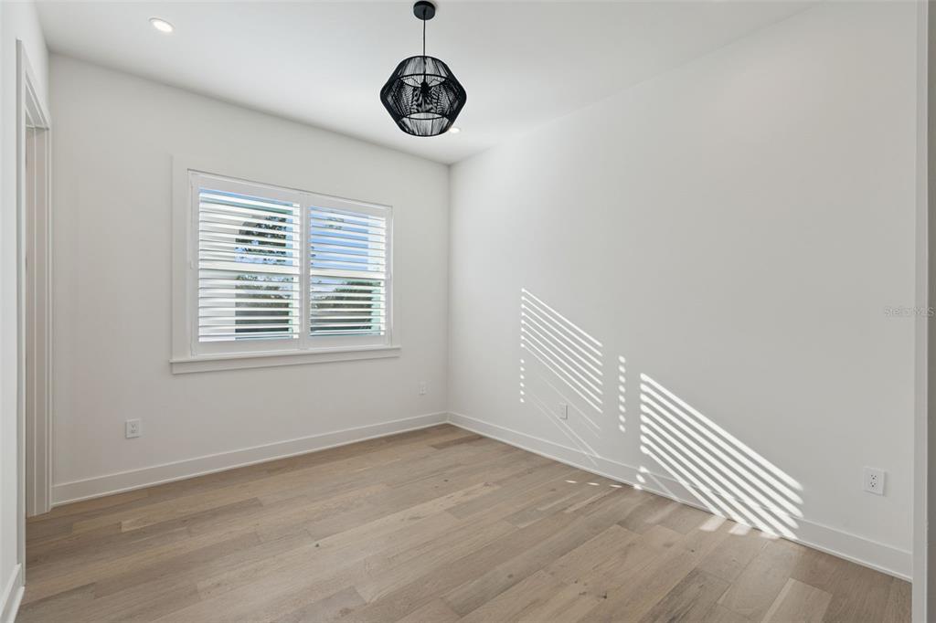 35 West Hazel Street Orlando, FL 32804 - Photo 41 of 60 a view of a room with wooden floor and windows