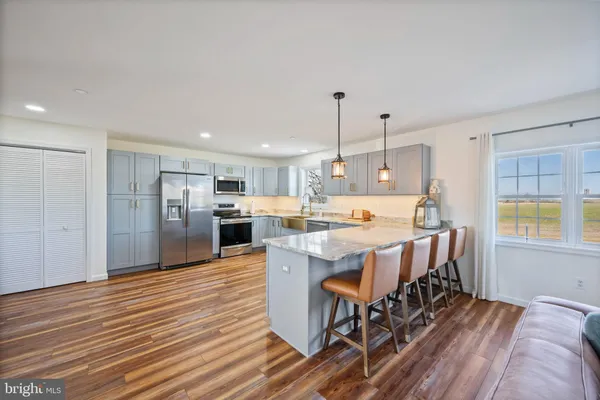 a large kitchen with a table and chairs