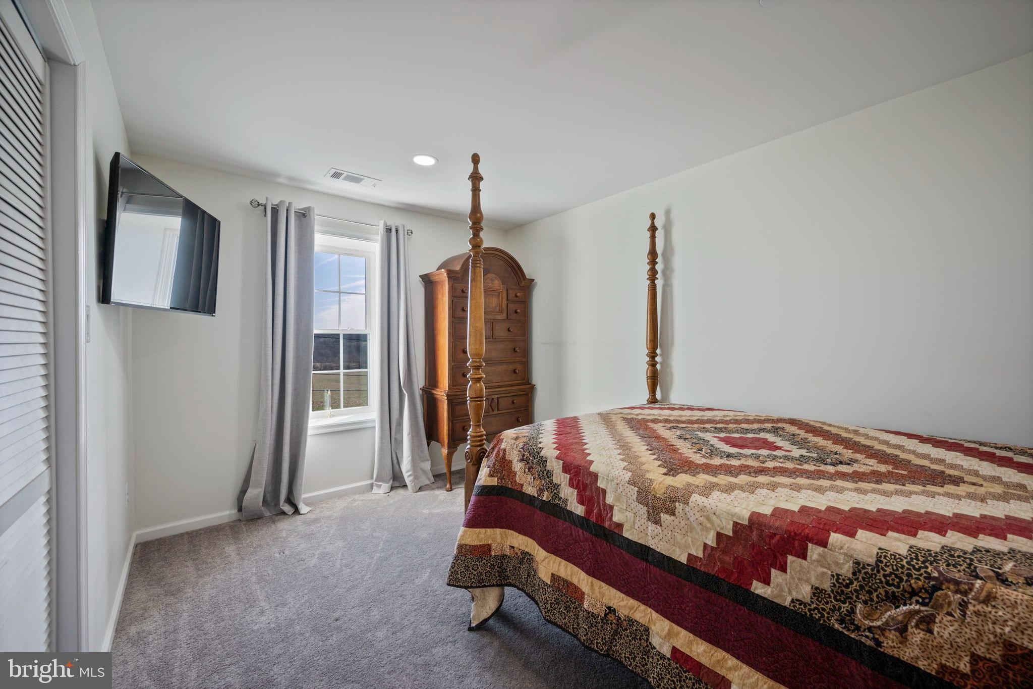 118 South Clear Ridge Road New Windsor, MD 21776 - Photo 23 of 44 a bedroom with a bed and a large mirror