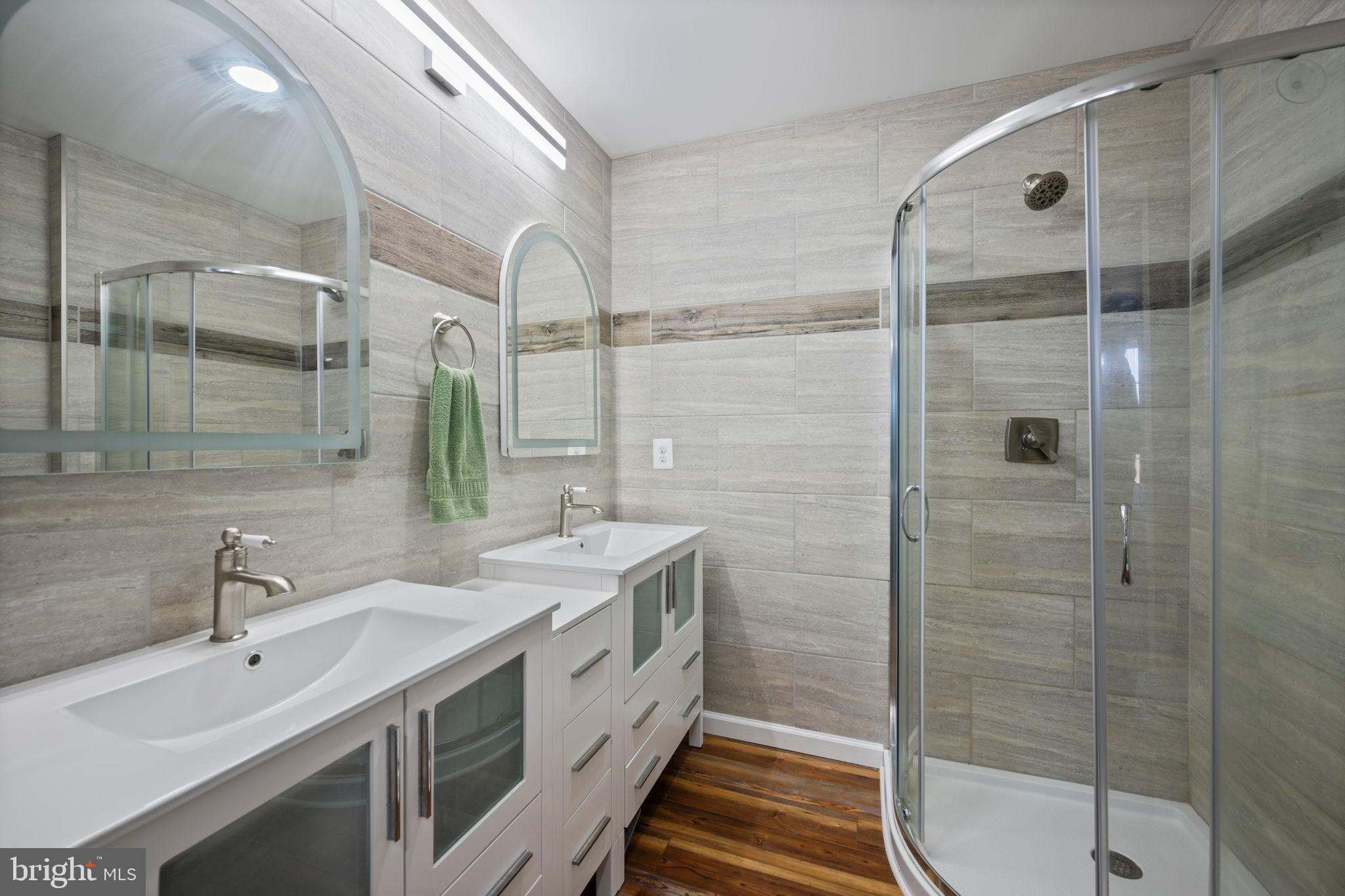 118 South Clear Ridge Road New Windsor, MD 21776 - Photo 30 of 44 a bathroom with a double vanity sink mirror and shower