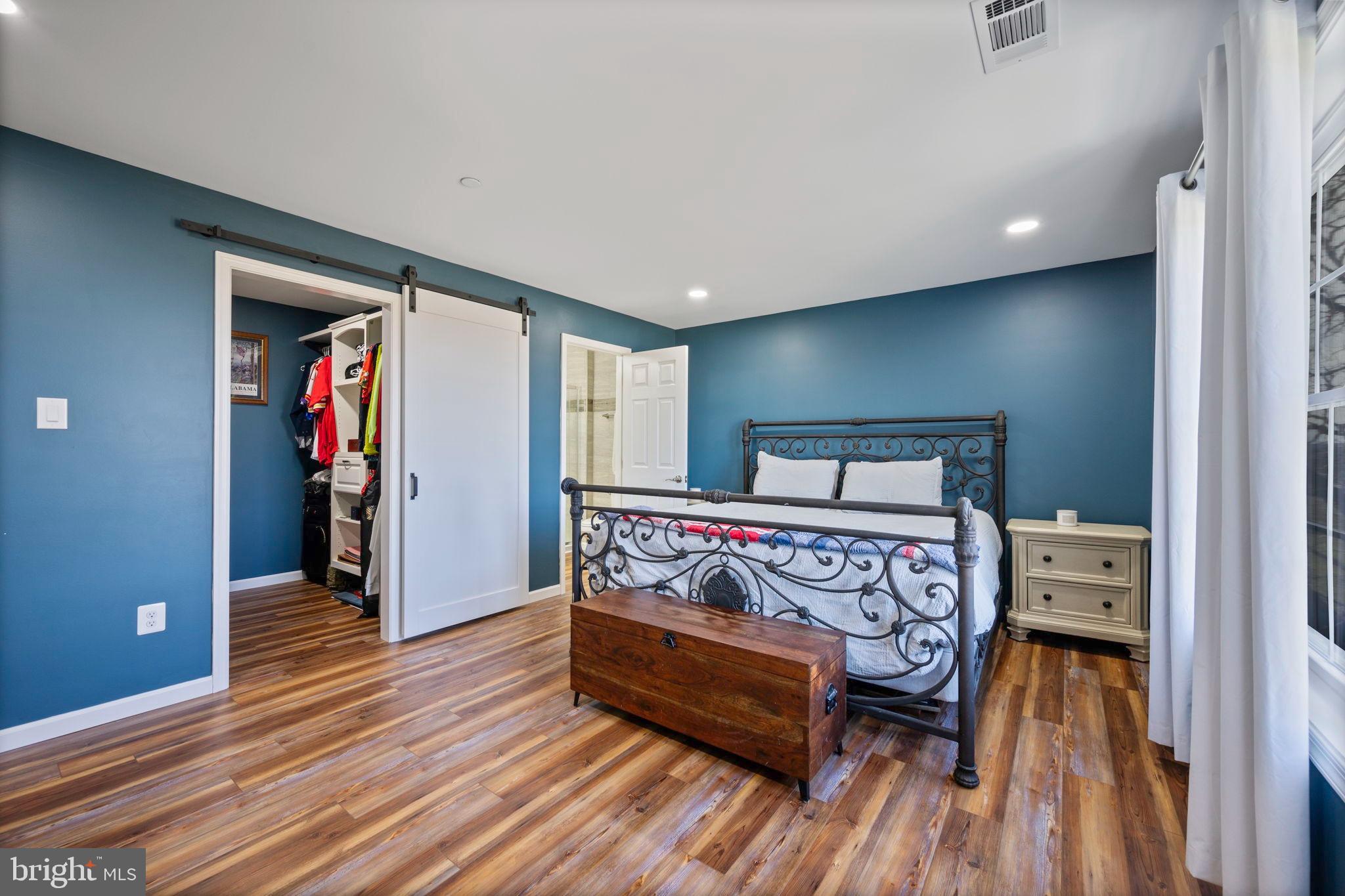 118 South Clear Ridge Road New Windsor, MD 21776 - Photo 31 of 44 a bedroom with a bed and a wooden floor