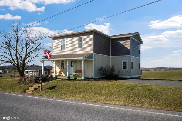 a front view of house with yard and green space