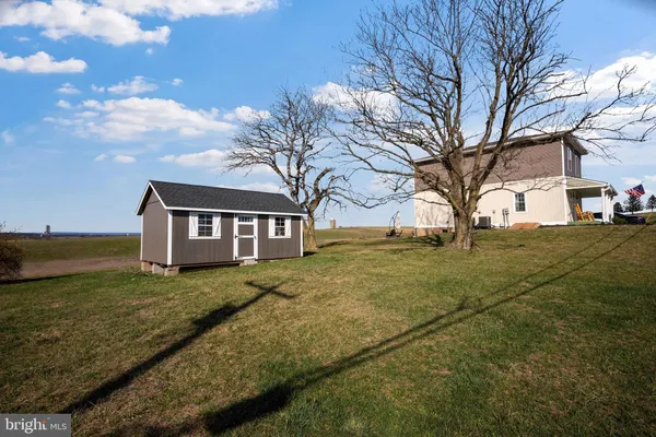 a view of a house with yard and tree s