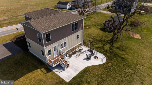 an aerial view of a house with a yard