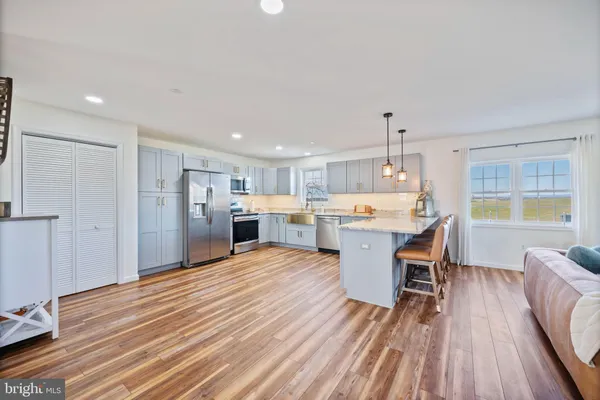 a large kitchen with a table and chairs