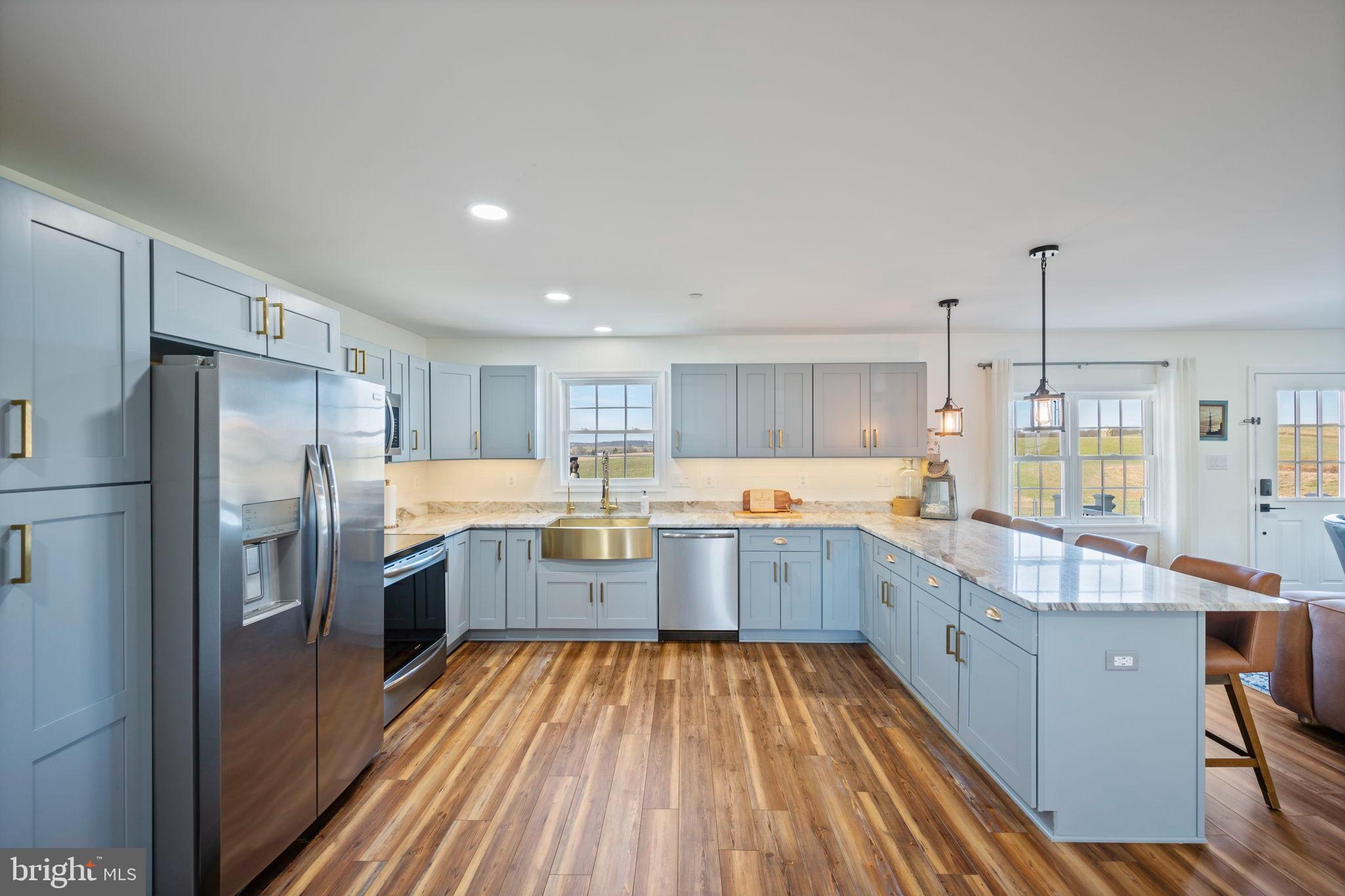 118 South Clear Ridge Road New Windsor, MD 21776 - Photo 8 of 44 a large kitchen with a large window and stainless steel appliances