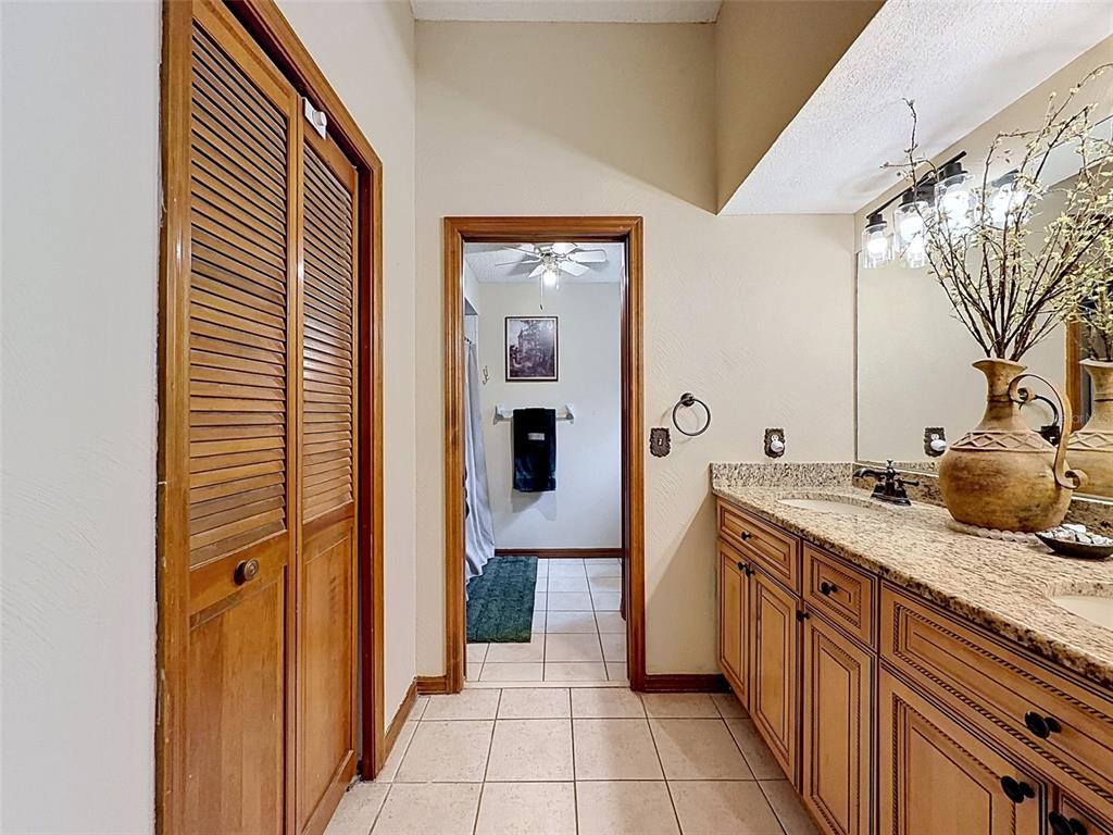 7111 Ricker Avenue Webster, FL 33597 - Photo 22 of 41 a bathroom with a granite countertop sink and a mirror