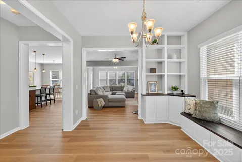 a living room with fireplace furniture and a chandelier
