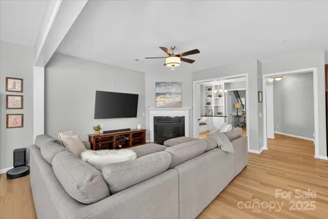 a living room with furniture a fireplace and a flat screen tv