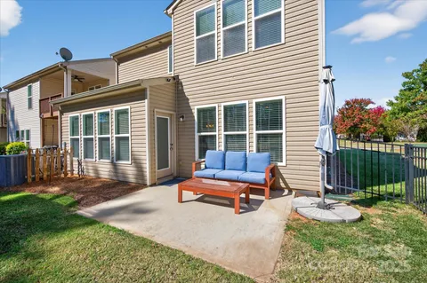 a view of a house with a yard and sitting area