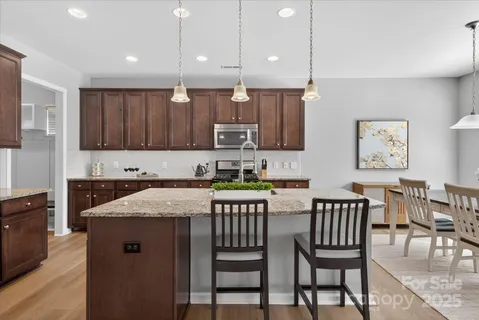 a kitchen with a table chairs and a refrigerator