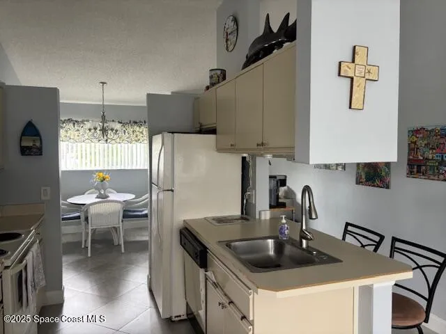a kitchen with stainless steel appliances granite countertop a sink and a refrigerator