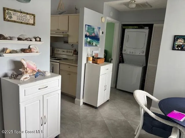 a kitchen with a refrigerator stove and white cabinets