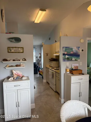 a kitchen with refrigerator a stove a sink and cabinets