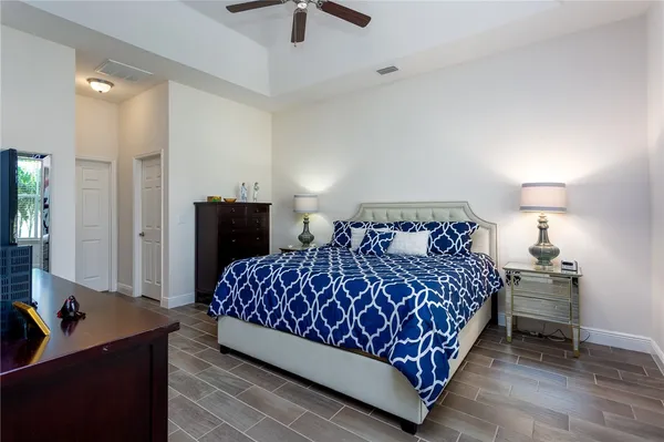 a large bed sitting in a bedroom next to a window