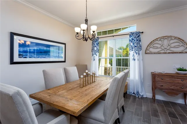 a dining room with furniture and a chandelier