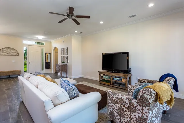 a large kitchen with granite countertop a stove refrigerator a sink a dining table and chairs