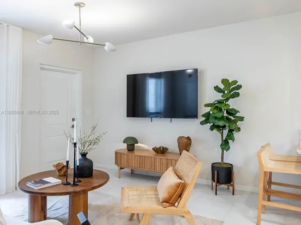 a living room with furniture and a potted plant