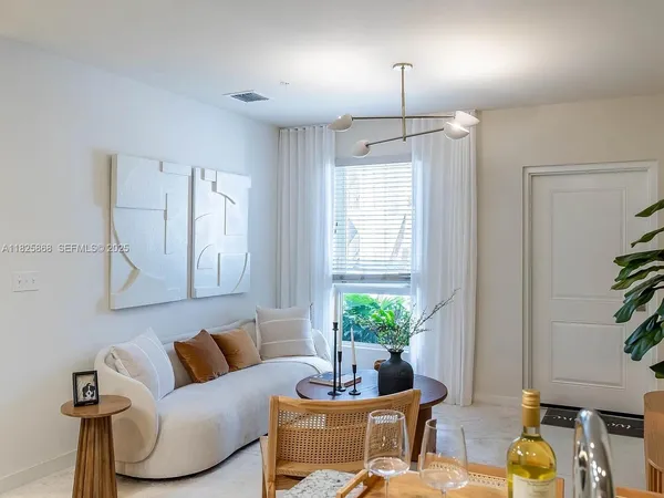 a living room with furniture and a potted plant
