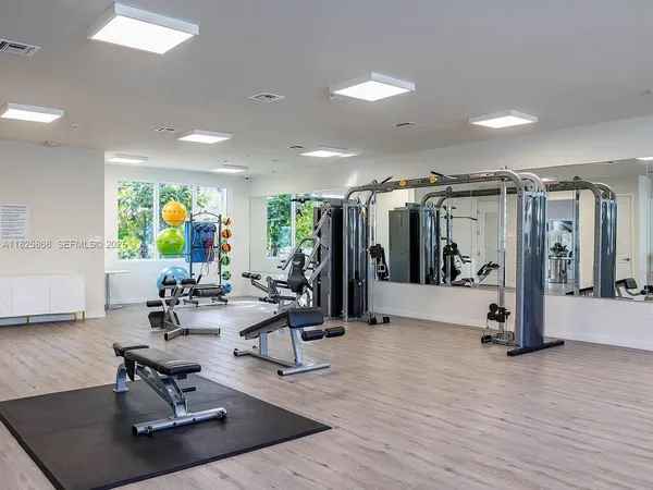 a view of a room with gym equipment and floor to ceiling window