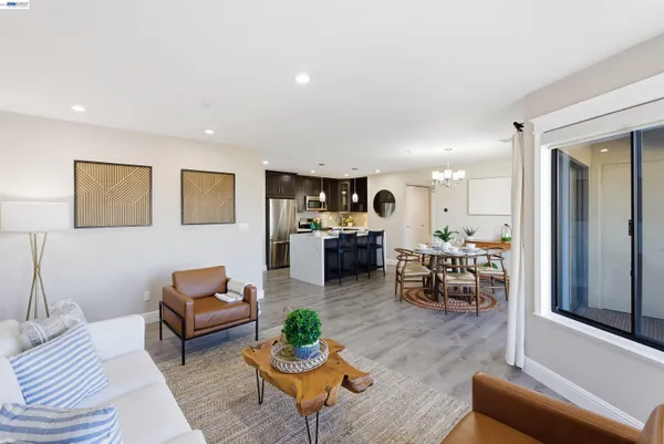 a living room with furniture kitchen view and a table