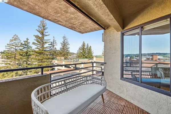a balcony with furniture and city view