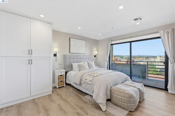 a spacious bedroom with a bed and a large window