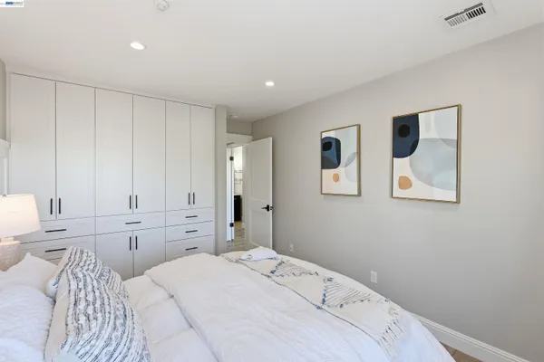 a bedroom with a bed and cabinets