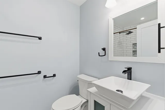 a white toilet sitting next to a bathroom sink