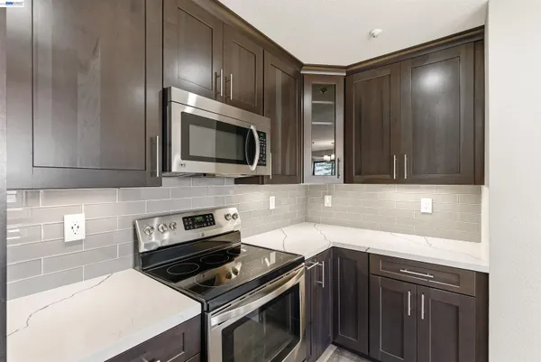 a kitchen with a sink stove and microwave