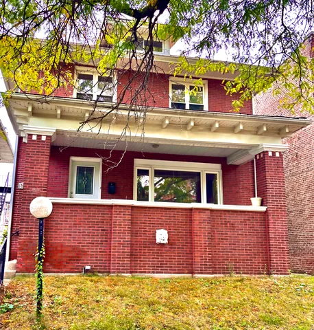 a view of a brick house with a large window